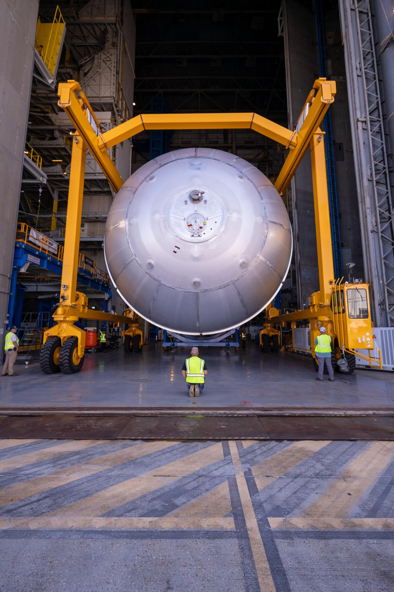 Teams at NASA’s Michoud Assembly Facility in New Orleans move a liquid oxygen tank from the main rocket factory into the adjacent vertical assembly building. The liquid oxygen tank, which will form part of the SLS (Space Launch System) rocket for NASA’s Artemis IV mission to the Moon, is rotated from a horizontal to a vertical configuration and loaded into the high bay’s hydrostatic proof testing cell. This non-destructive evaluation method tests the structural integrity of the tank’s welds by filling the tank with water, simulating the propellant used during launch. The propellant tank will hold more than 196,000 gallons of super-cooled liquid oxygen at launch and is one of five major elements that make up the 212-foot-tall SLS rocket stage. The core stage, along with its four RS-25 engines at its base, produces more than two million pounds of thrust to help launch NASA’s Orion spacecraft, astronauts, and supplies beyond Earth’s orbit and to the lunar surface for Artemis.